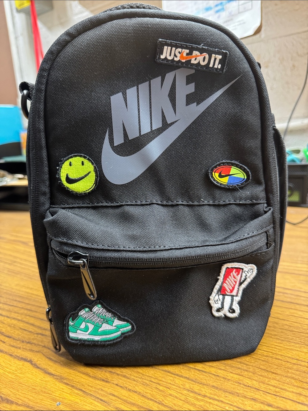 Nike Black Mini Crossbody Backpack with Gray Swoosh and Colorful Patches